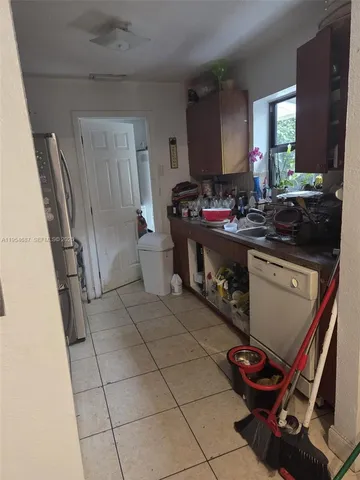 a kitchen with a sink appliances and cabinets