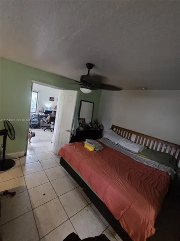 a bedroom with bed and window