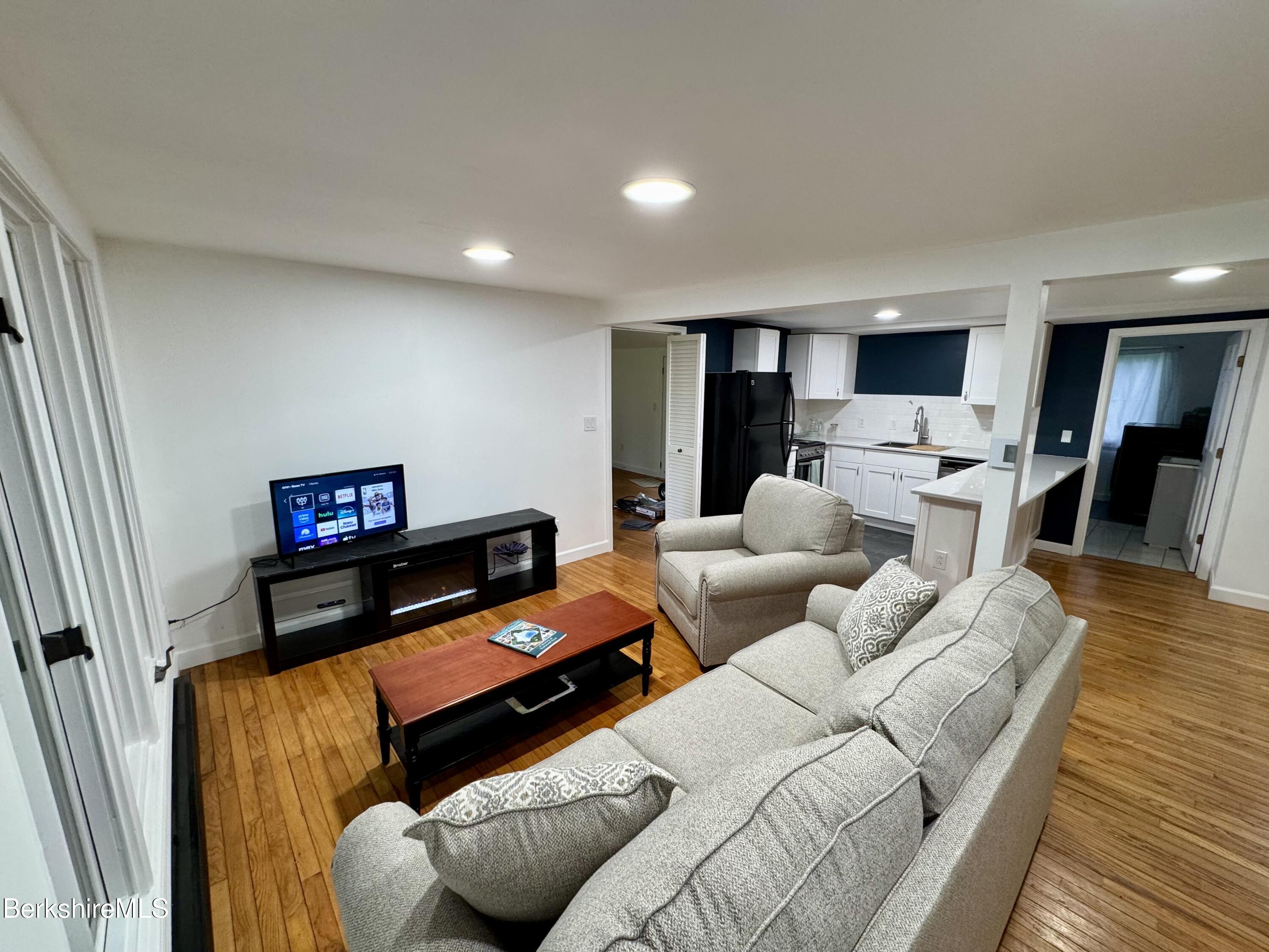 129 Shore Road Richmond, MA 01201 - Photo 5 of 14 a living room with furniture and a flat screen tv