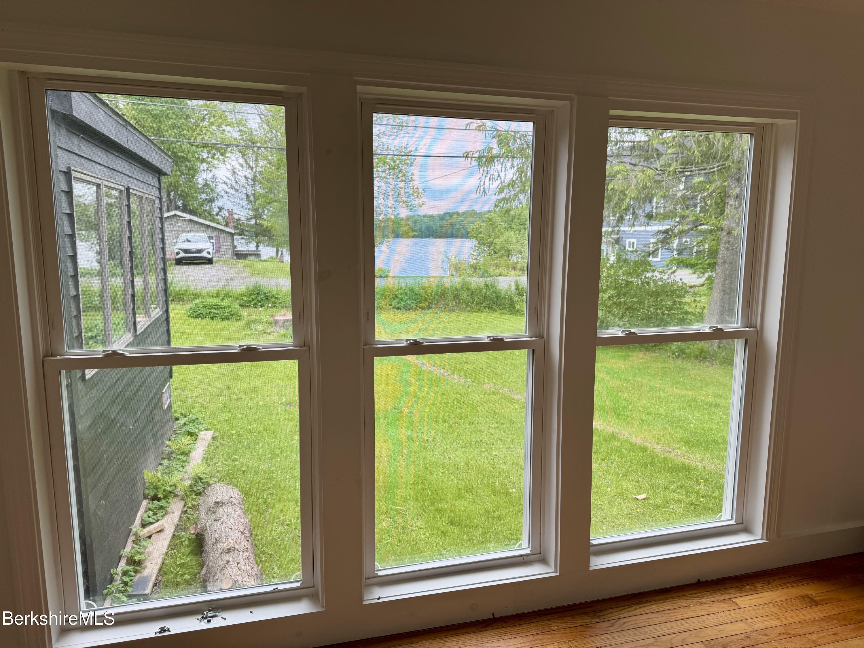129 Shore Road Richmond, MA 01201 - Photo 8 of 14 a view of a room with a large window and bed