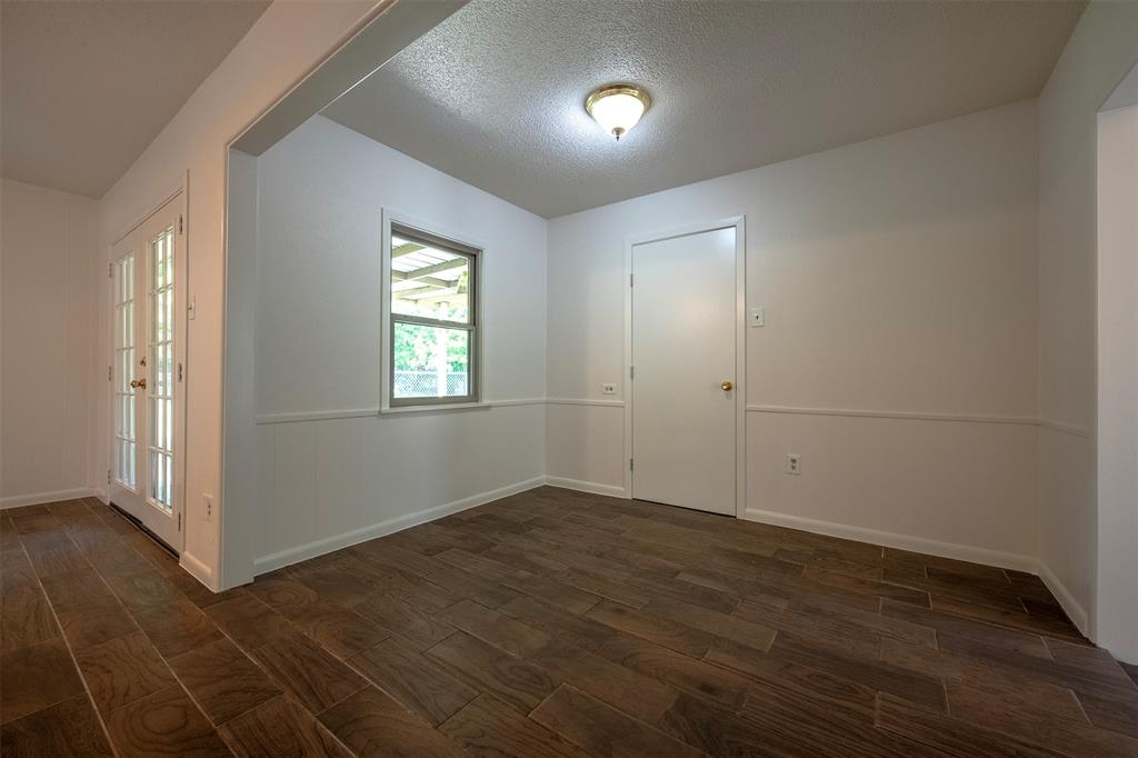 610 East Anderson Street Weatherford, TX 76086 - Photo 11 of 25 an empty room with wooden floor and windows