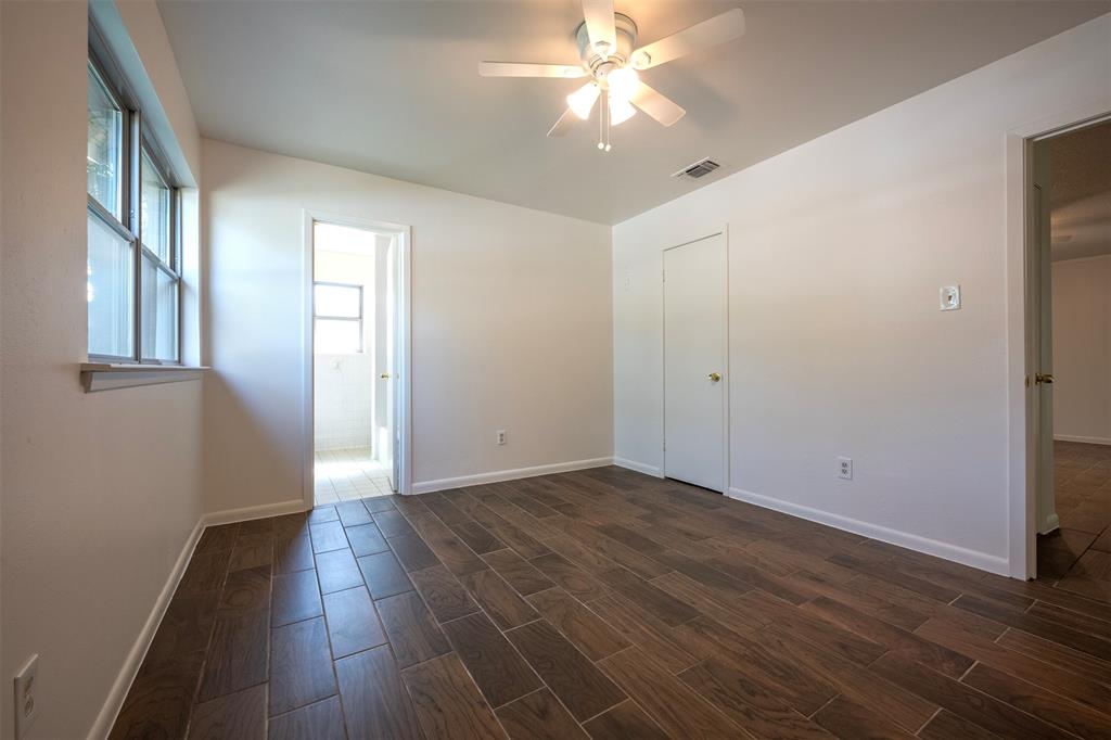 610 East Anderson Street Weatherford, TX 76086 - Photo 5 of 25 a view of an empty room with wooden floor and a window