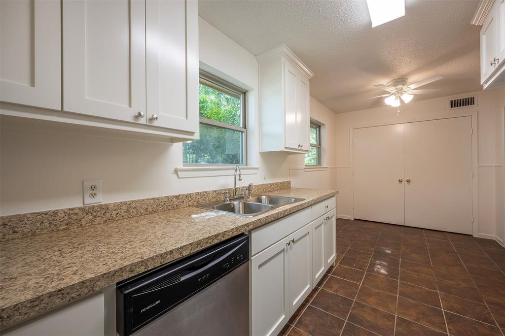 610 East Anderson Street Weatherford, TX 76086 - Photo 8 of 25 a kitchen with a sink and cabinets