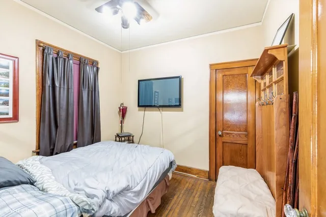 a bedroom with a bed dresser and a large mirror