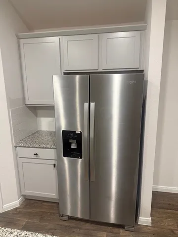 a view of a refrigerator in kitchen and dishwasher