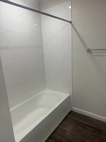 a bathroom with a bathtub and a shower