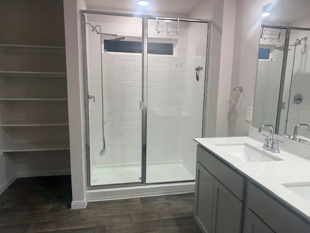 a bathroom with a shower and a sink