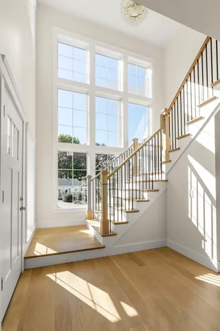 a spacious bedroom with a large bed and a chandelier