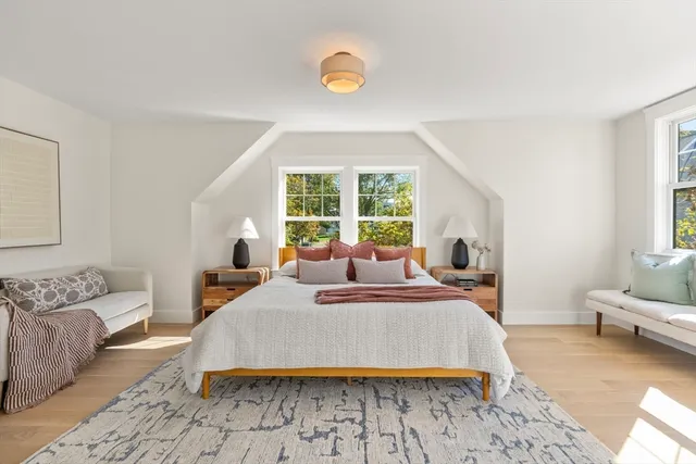 a bed room with a bed and a chair