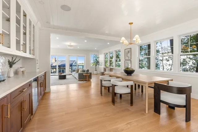 a room with lots of wooden furniture and a chandelier