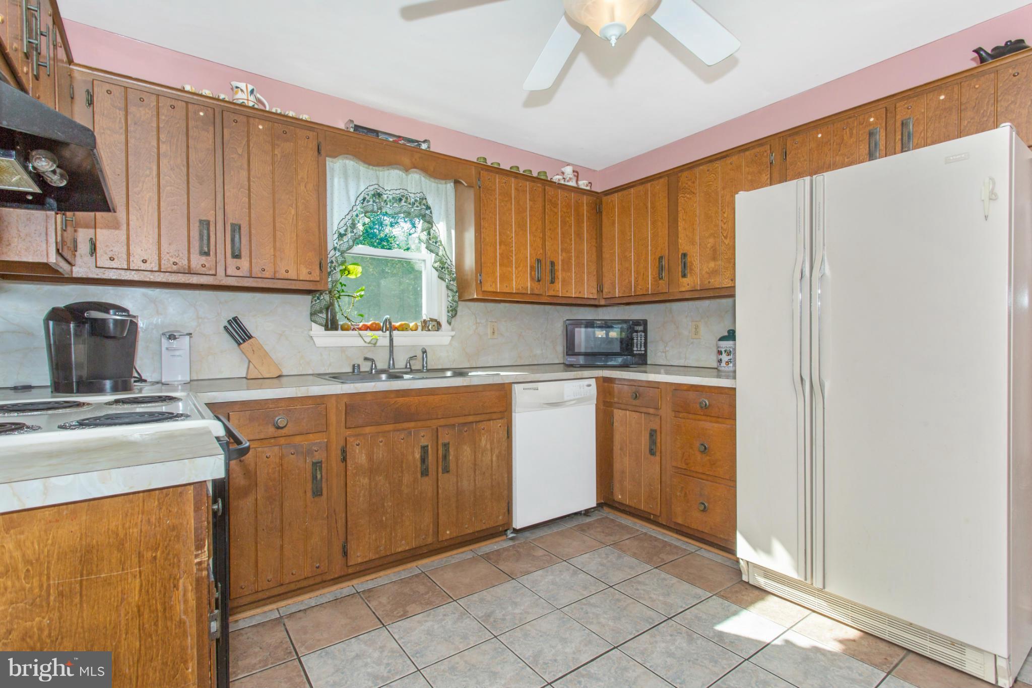 1838 Pleasant View Road Adamstown, MD 21710 - Photo 12 of 26 a kitchen with stainless steel appliances granite countertop a refrigerator sink and cabinets