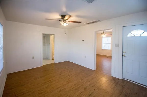 wooden floor in an empty room with a window