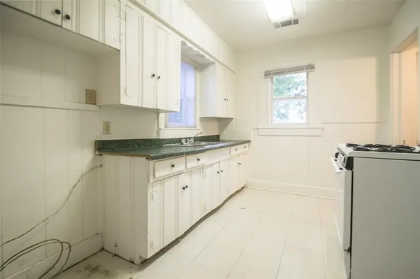 a kitchen with a stove and a shower