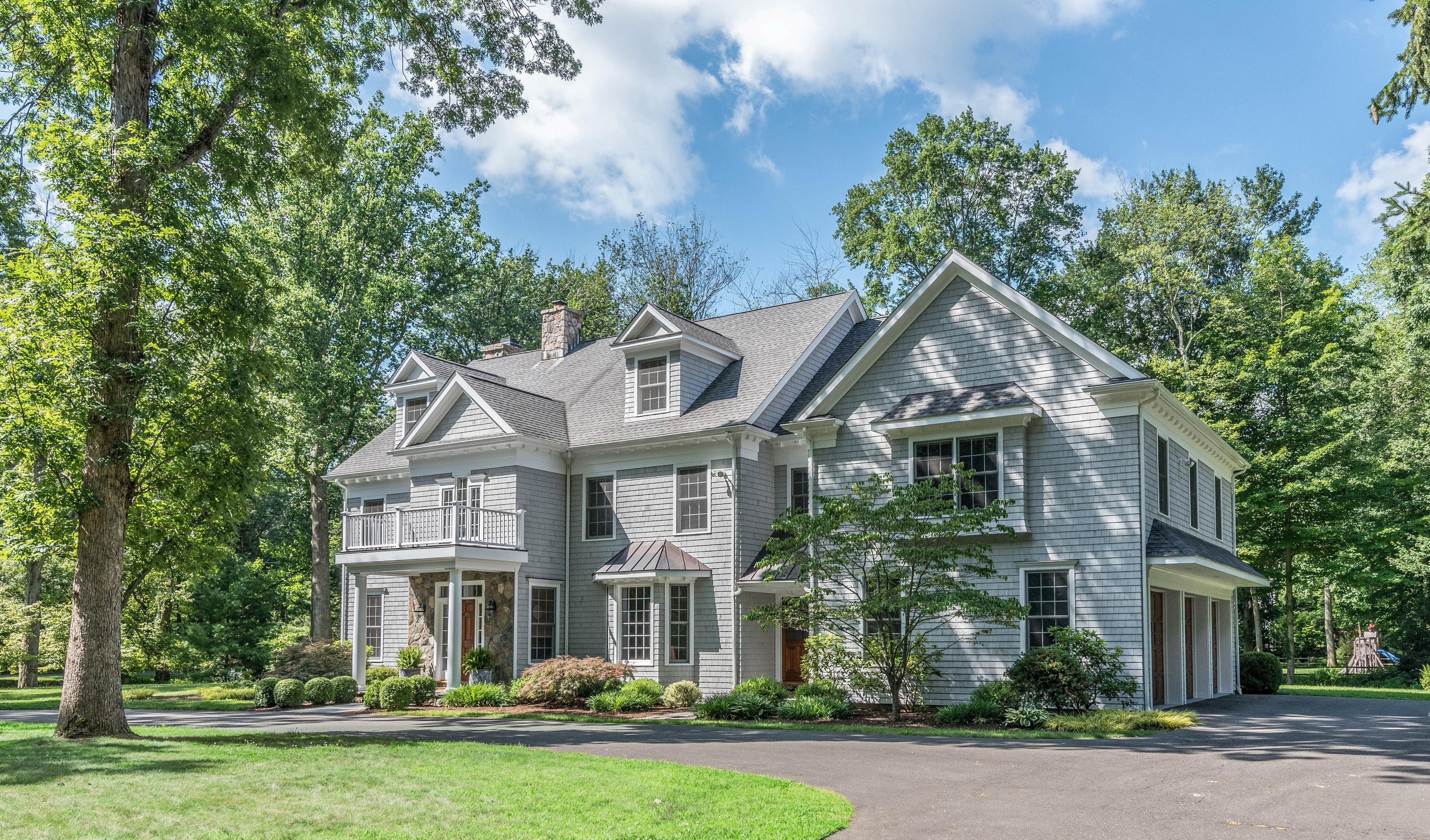 42 Mariomi Road New Canaan, CT 06840 - Photo 1 of 28 a front view of a house with a garden