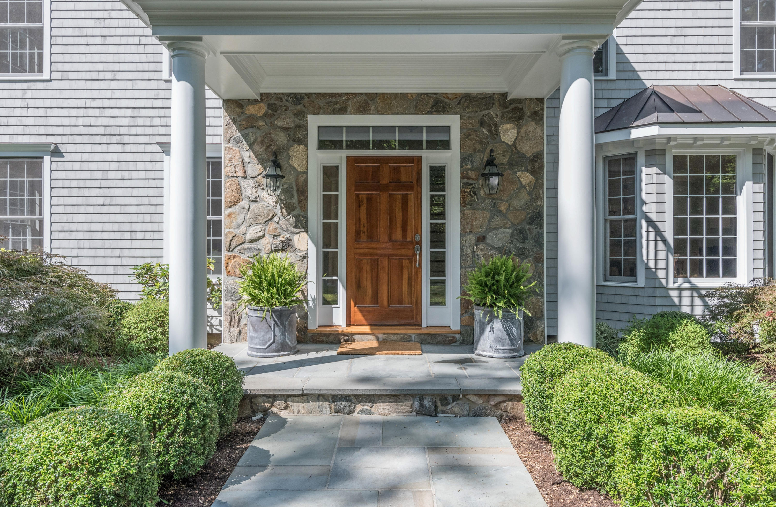 42 Mariomi Road New Canaan, CT 06840 - Photo 2 of 28 a front view of a house with a yard