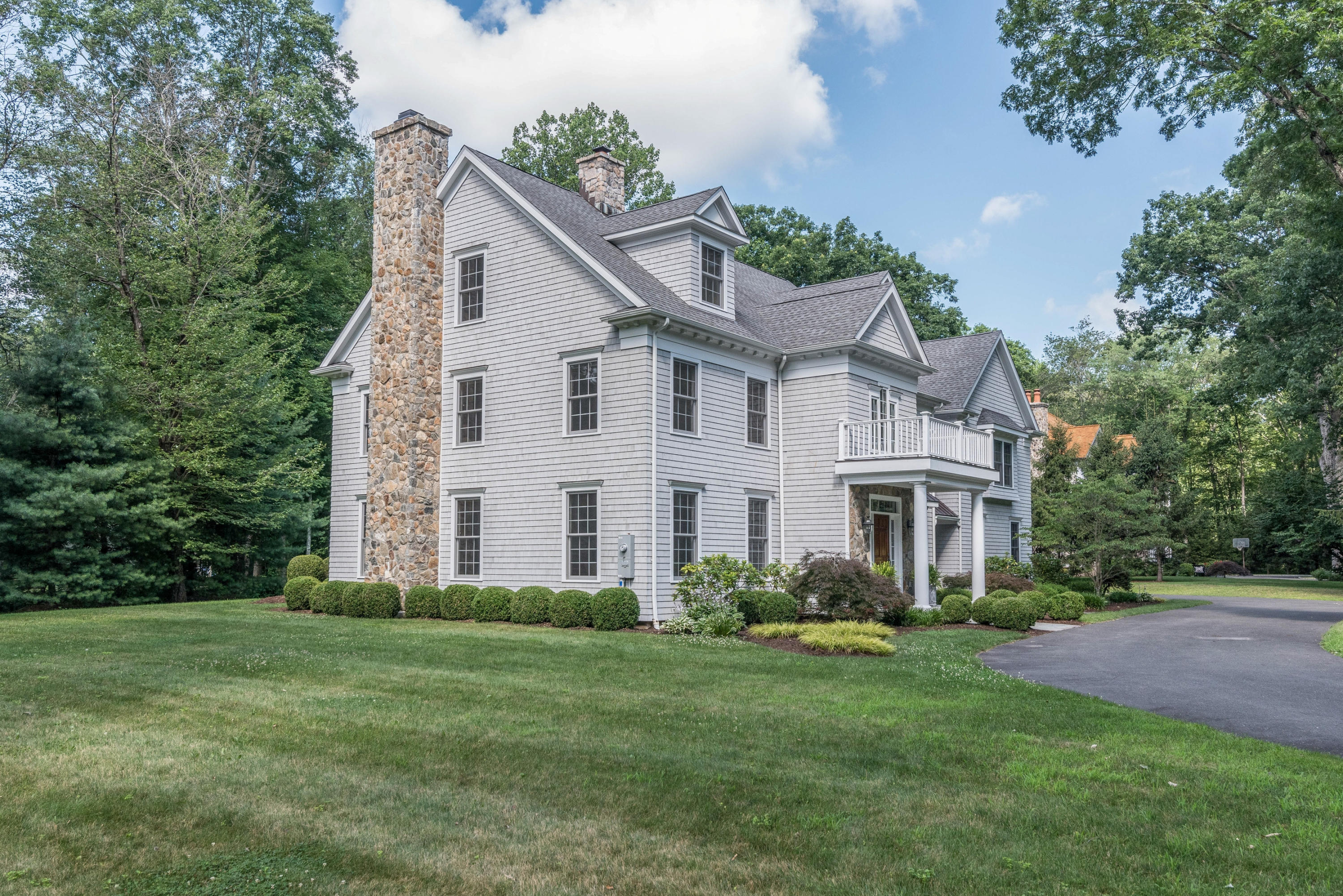 42 Mariomi Road New Canaan, CT 06840 - Photo 25 of 28 a front view of a house with a garden