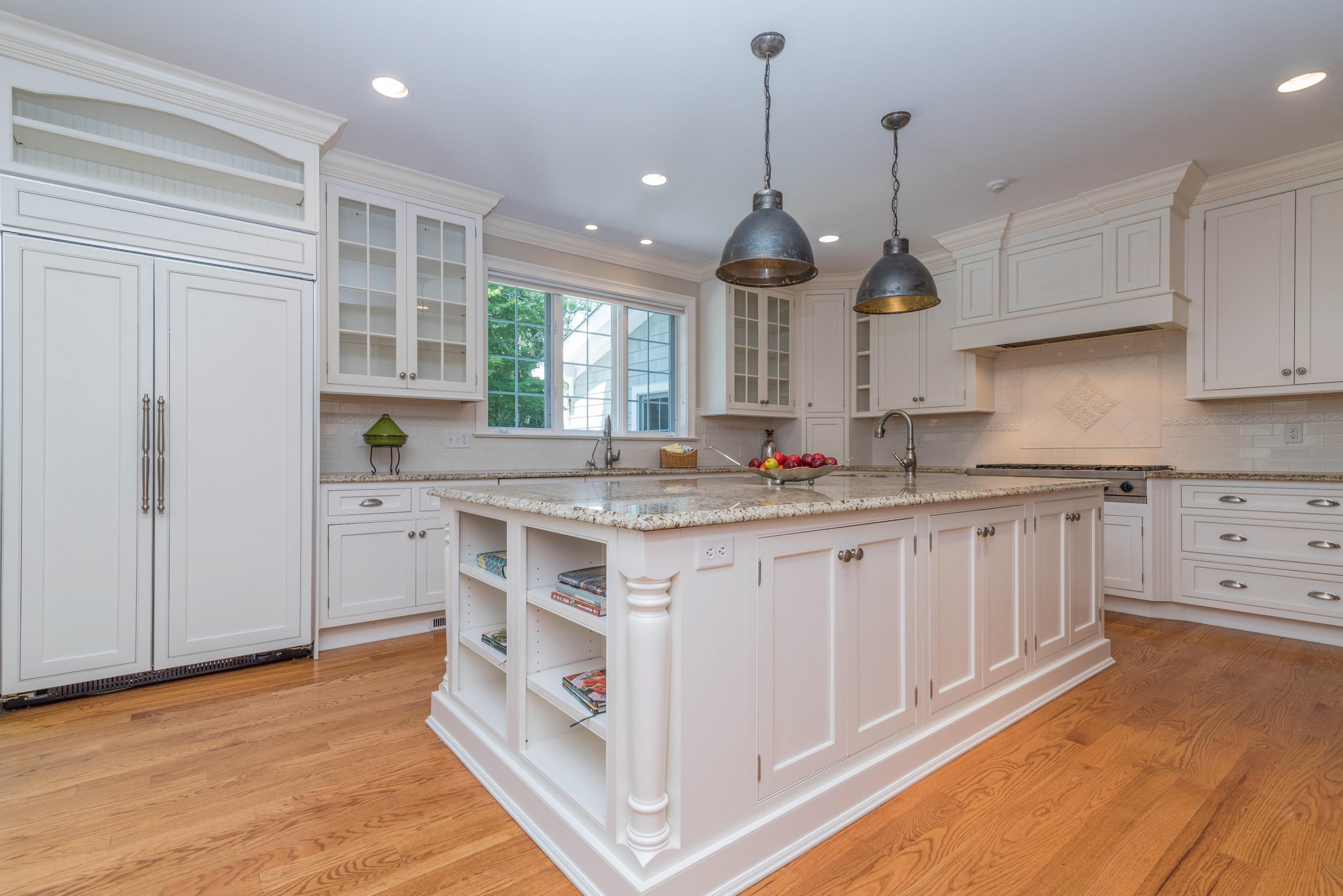 42 Mariomi Road New Canaan, CT 06840 - Photo 9 of 28 a kitchen with granite countertop a sink cabinets and wooden floor