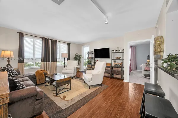 a living room with furniture and a flat screen tv