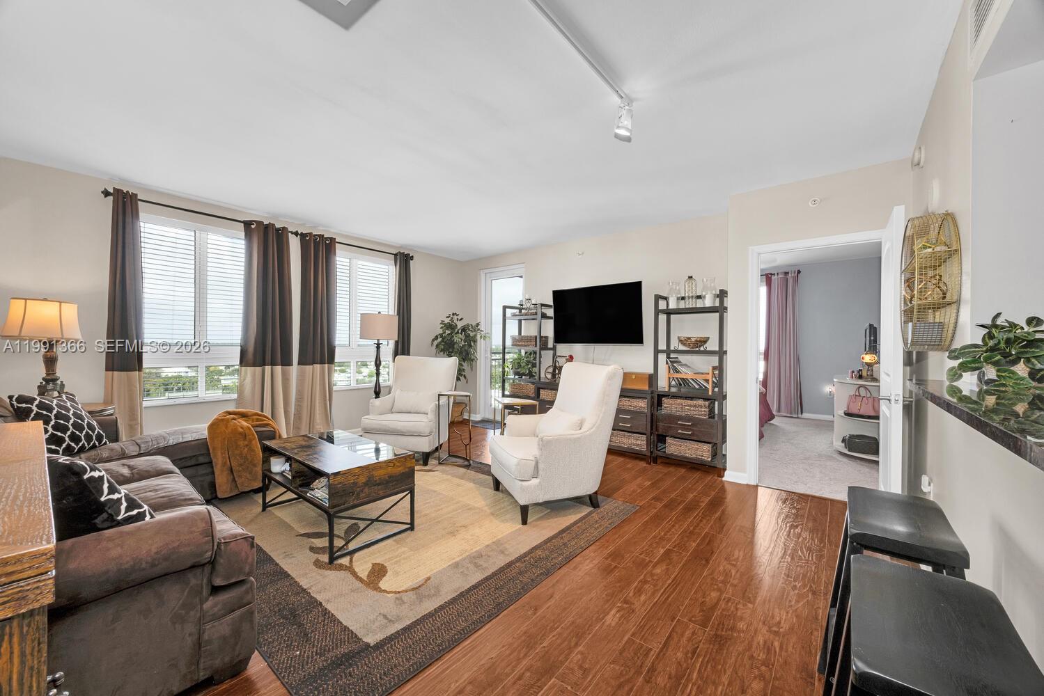 a living room with furniture and a flat screen tv