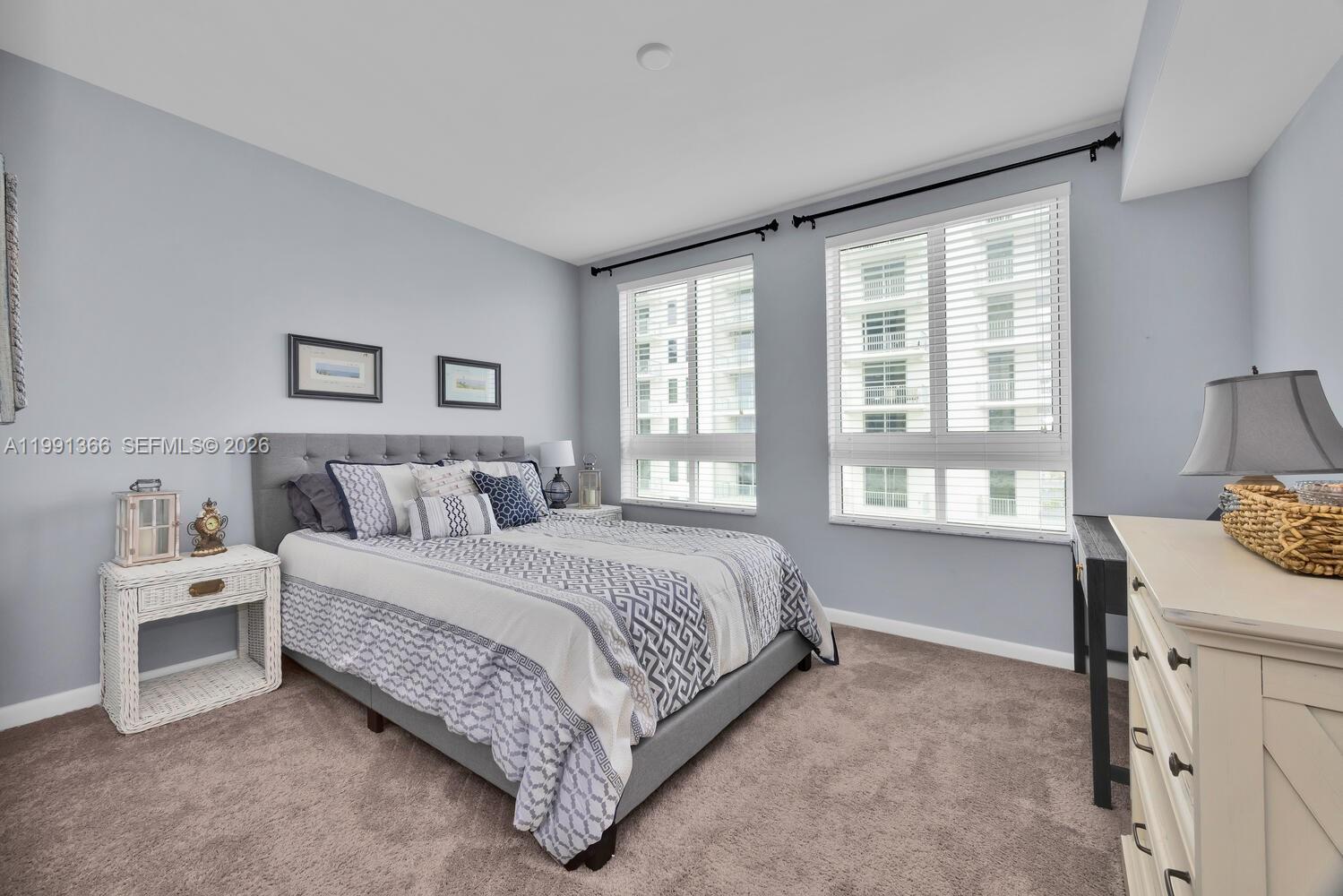 7350 Southwest 89th Street, Unit 1511S Miami, FL 33156 - Photo 12 of 29 a spacious bedroom with a bed and a table