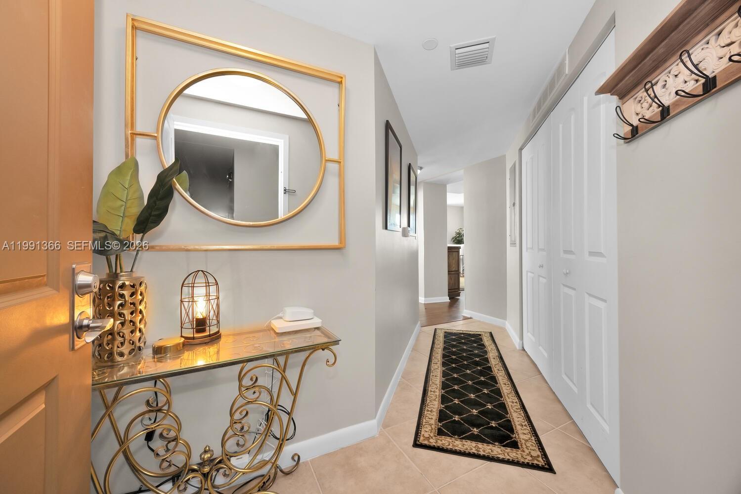 7350 Southwest 89th Street, Unit 1511S Miami, FL 33156 - Photo 2 of 29 a bathroom with a mirror a sink and a mirror