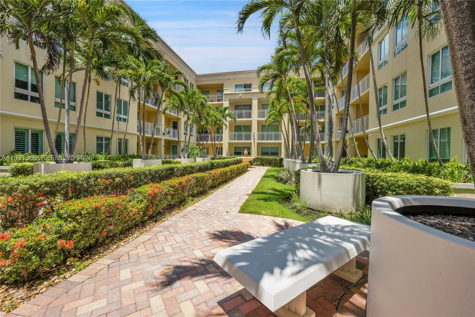7350 Southwest 89th Street, Unit 1511S Miami, FL 33156 - Photo 25 of 29 a view of a building with a garden