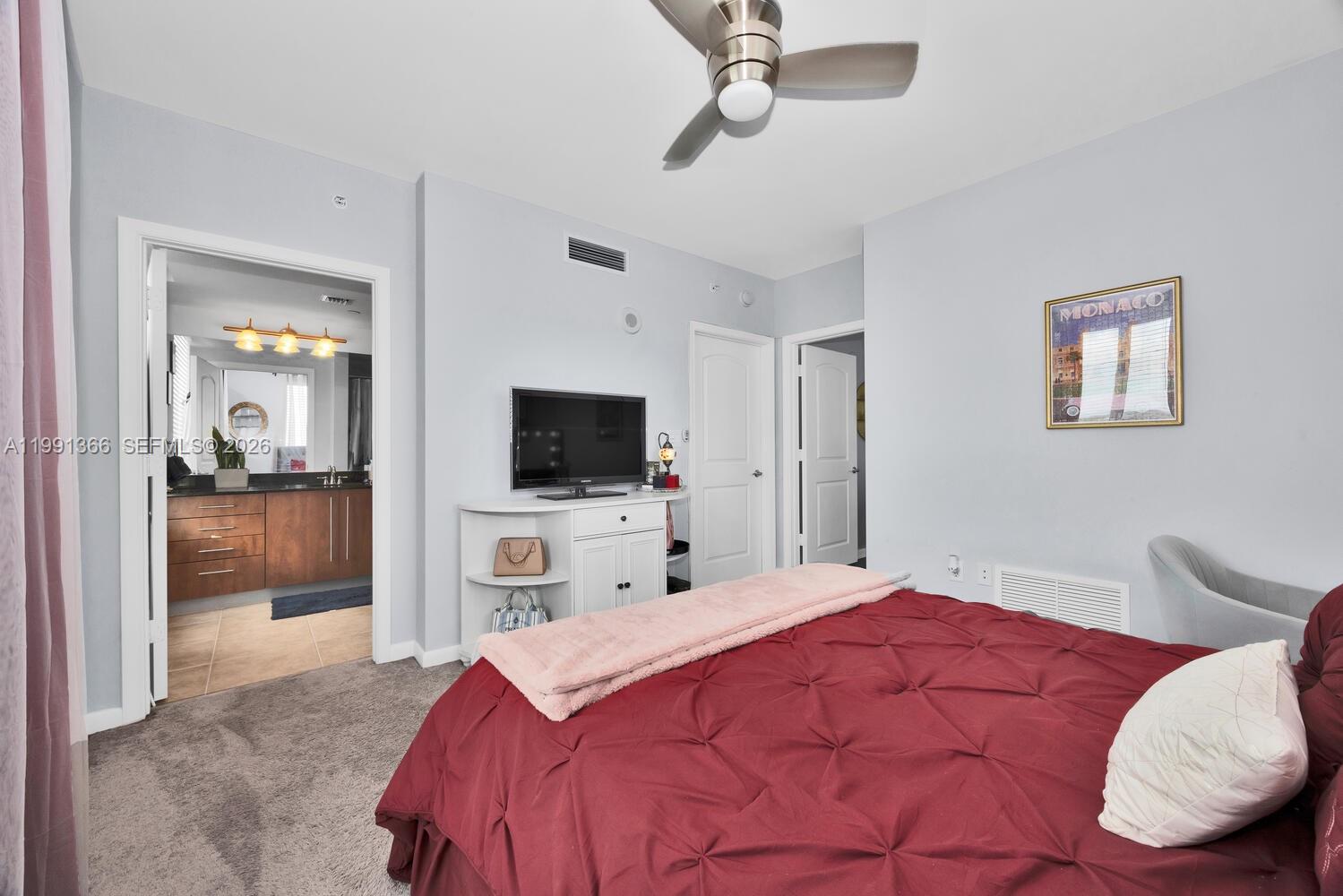 7350 Southwest 89th Street, Unit 1511S Miami, FL 33156 - Photo 10 of 29 a bedroom with a bed and a flat screen tv