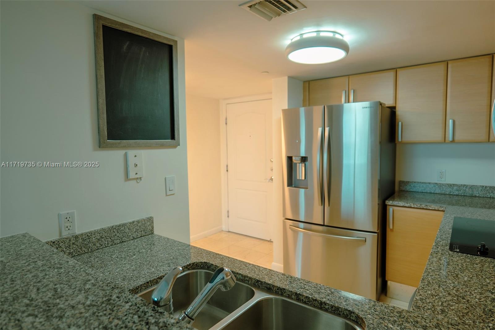 2101 Brickell Avenue, Unit 2103 Miami, FL 33129 - Photo 12 of 35 a kitchen with a refrigerator and a sink