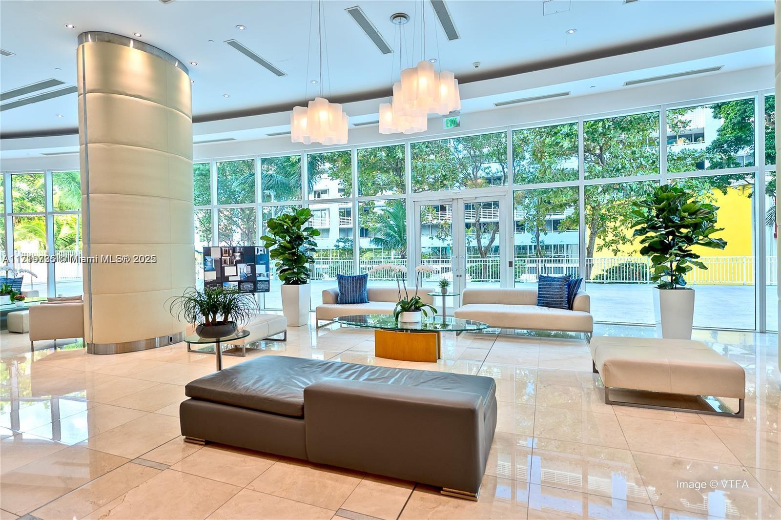 2101 Brickell Avenue, Unit 2103 Miami, FL 33129 - Photo 21 of 35 a living room with furniture and a large window