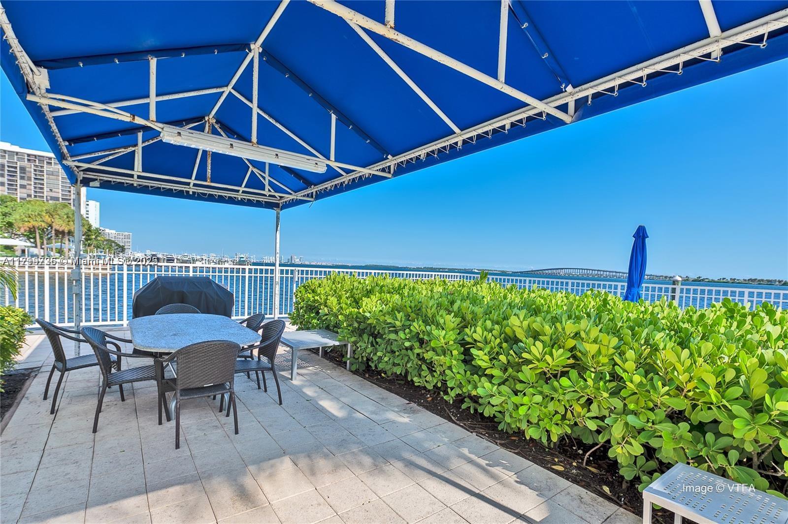 2101 Brickell Avenue, Unit 2103 Miami, FL 33129 - Photo 34 of 35 a patio with table and chairs