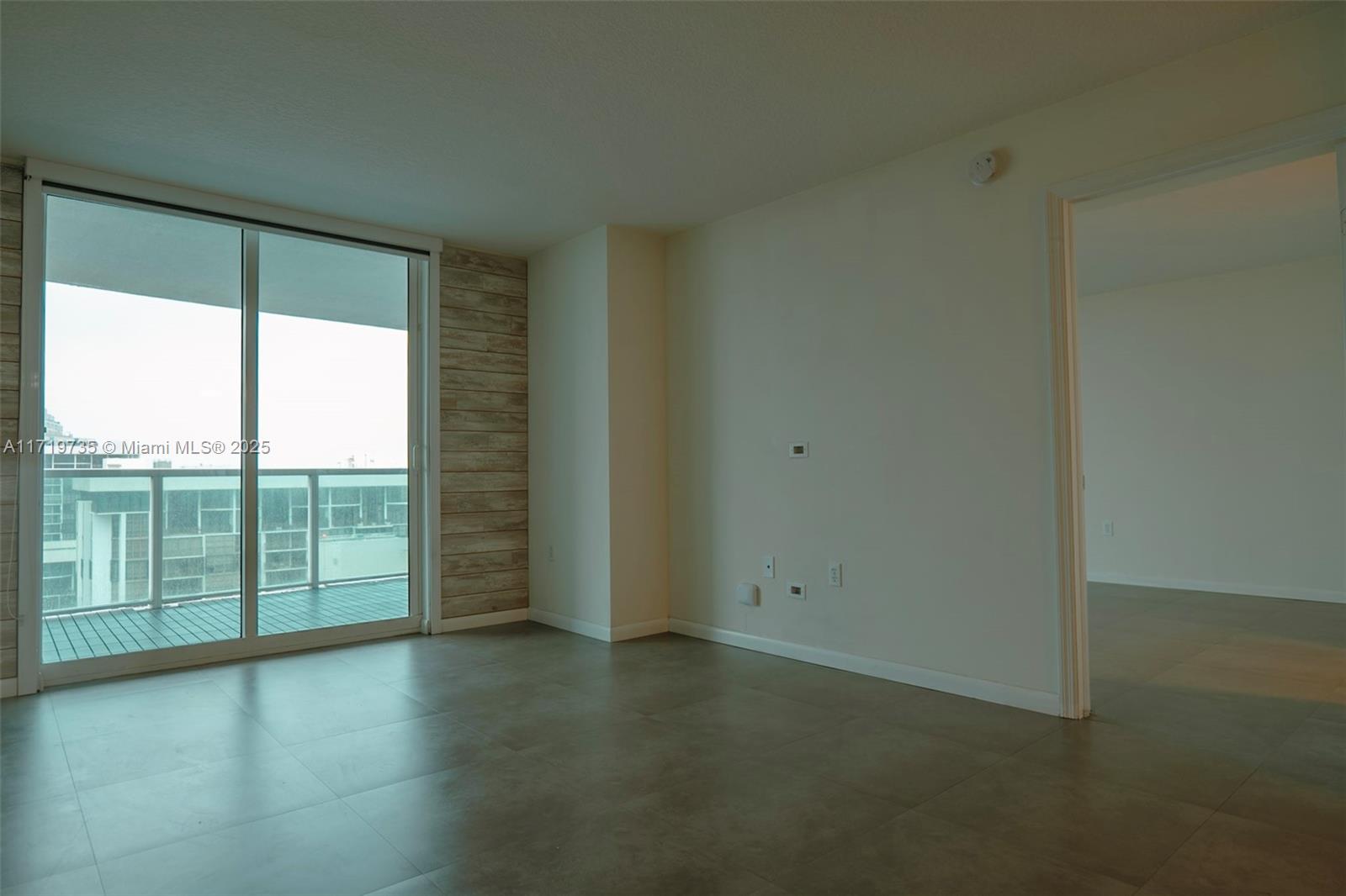 2101 Brickell Avenue, Unit 2103 Miami, FL 33129 - Photo 9 of 35 an empty room with wooden floor and windows