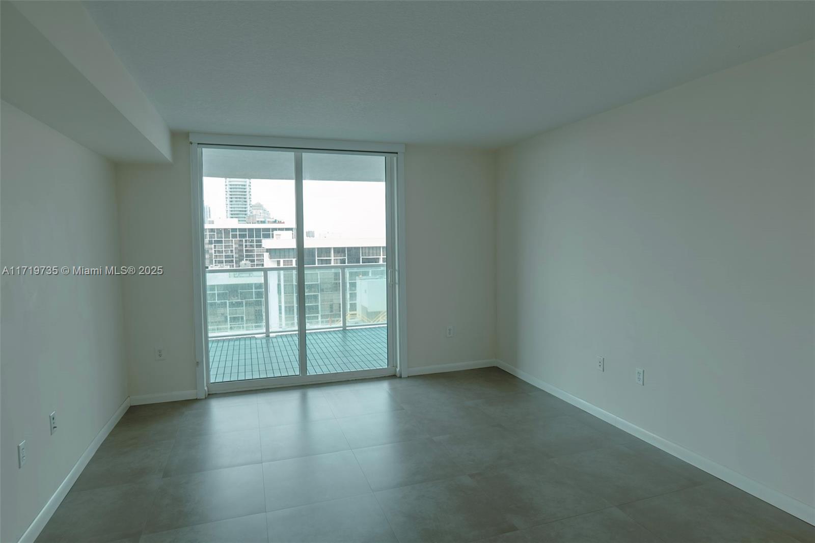 2101 Brickell Avenue, Unit 2103 Miami, FL 33129 - Photo 10 of 35 an empty room with wooden floor and windows