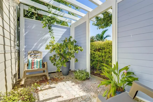 a couple of potted plants in front of door