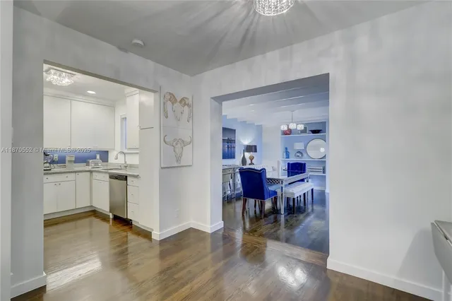 a kitchen with white cabinets and counter space