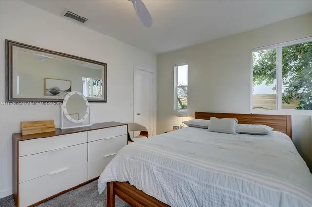 a bedroom with a large bed and a dresser