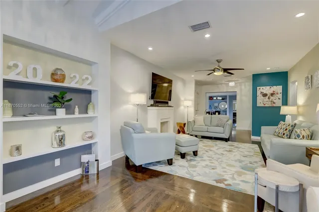 a living room with furniture and flat screen tv