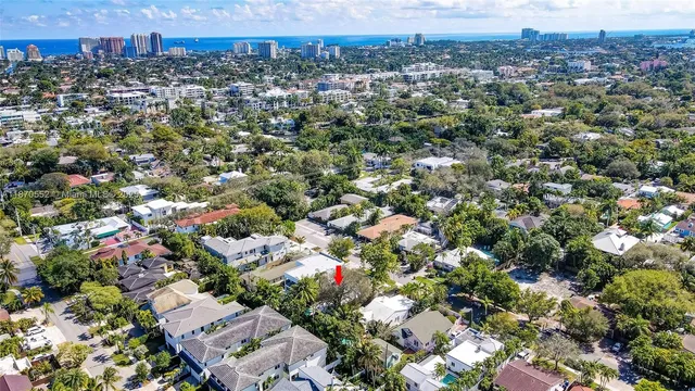an aerial view of a residential houses with city view