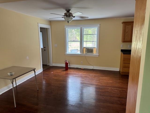 Open concept living space featuring wood-finish flooring and a ceiling fan