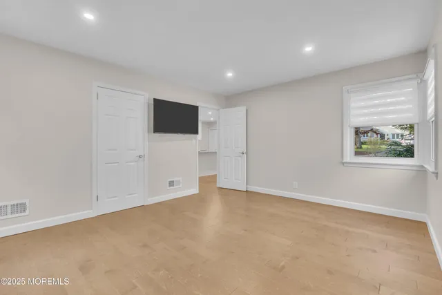 a view of an empty room with a window