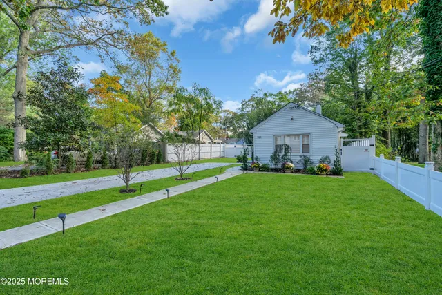a house with green field in front of it
