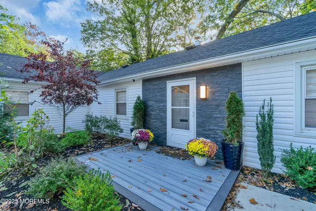 a view of table and chairs with potted plants