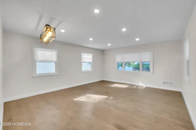 an empty room with windows and glass wall