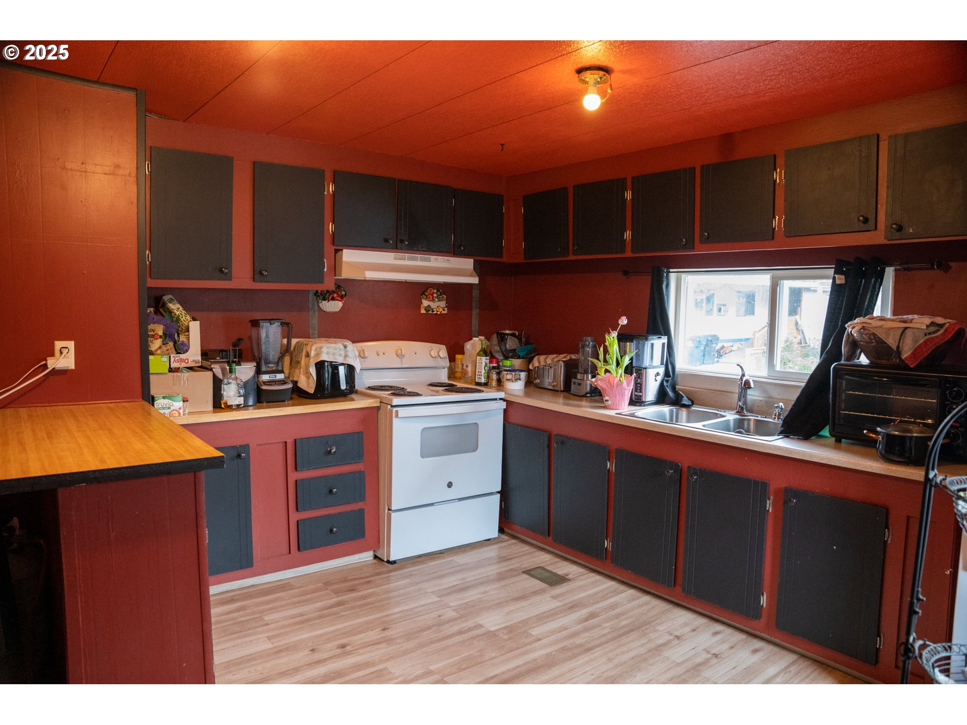 5335 Daisy Street, Unit TL 0130 Springfield, OR 97478 - Photo 14 of 17 a kitchen with stainless steel appliances granite countertop a stove a sink dishwasher and cabinets with wooden floor