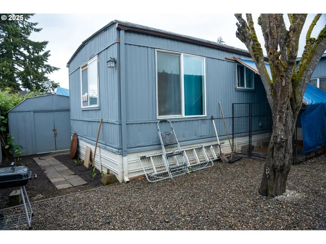 a backyard of a house with table and chairs