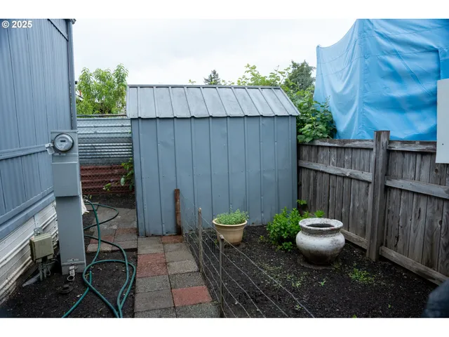 a view of a backyard with furniture and garden