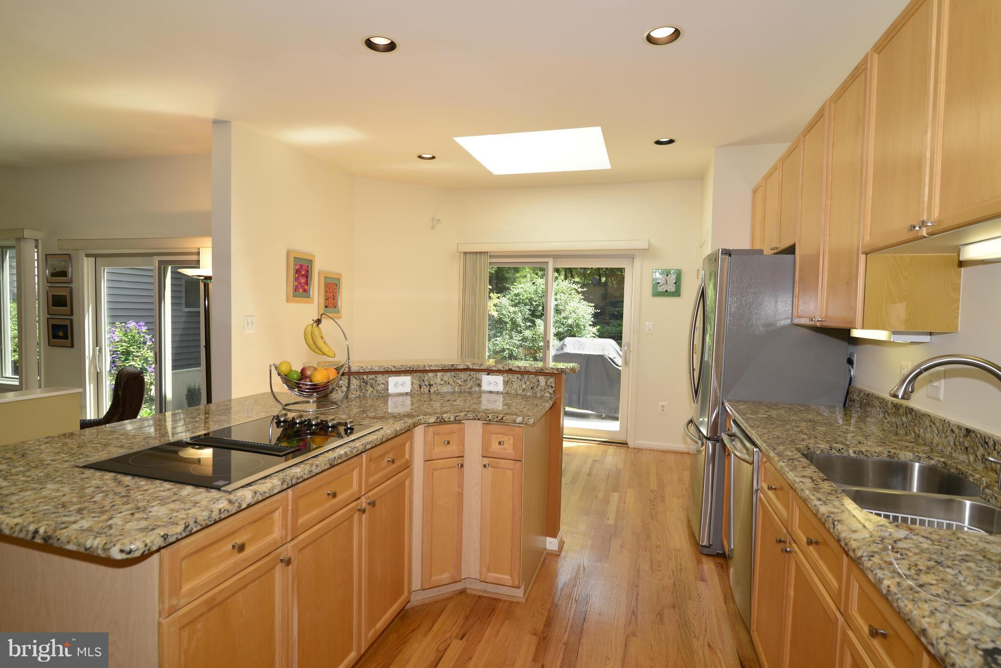 2015 Beacon Place Reston, VA 20191 - Photo 7 of 22 a kitchen with granite countertop a sink stove and refrigerator