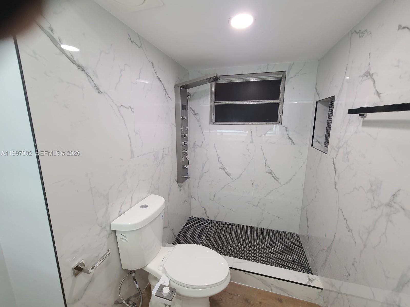 2980 Riverside Drive, Unit 1253 Coral Springs, FL 33065 - Photo 11 of 18 a white toilet sitting next to a bath tub