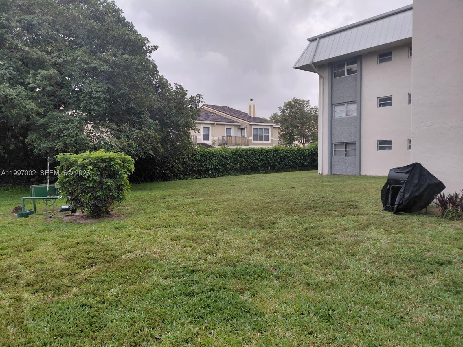 2980 Riverside Drive, Unit 1253 Coral Springs, FL 33065 - Photo 14 of 18 a view of a chair and fire pit in front of a house