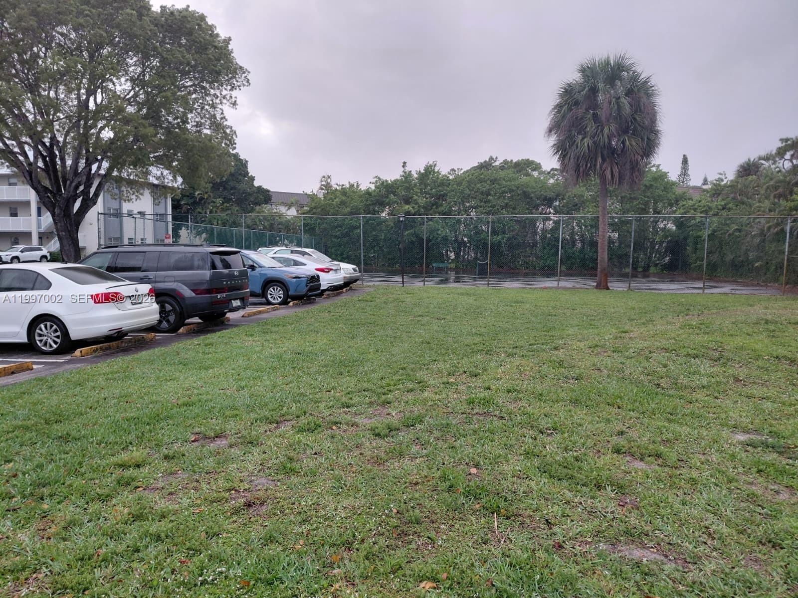 2980 Riverside Drive, Unit 1253 Coral Springs, FL 33065 - Photo 16 of 18 a yellow and red house sitting in the middle of a field