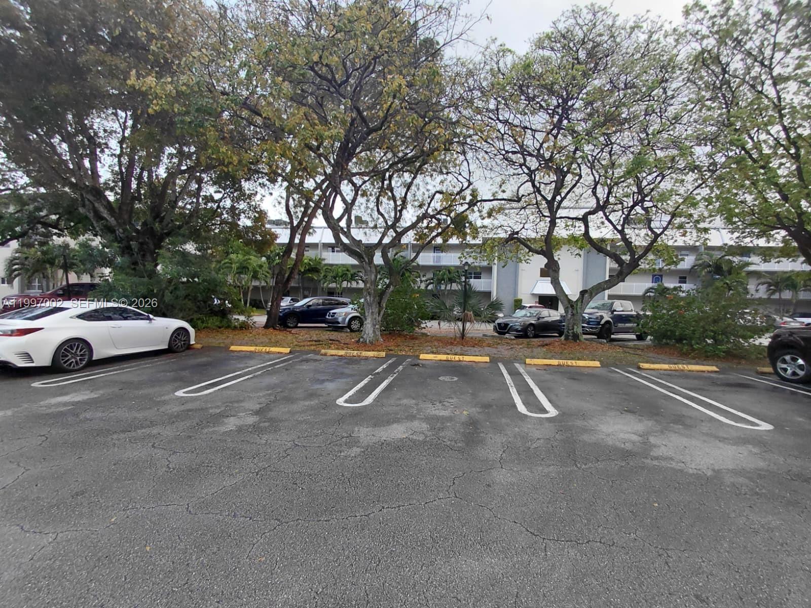 2980 Riverside Drive, Unit 1253 Coral Springs, FL 33065 - Photo 18 of 18 a view of street with parked cars